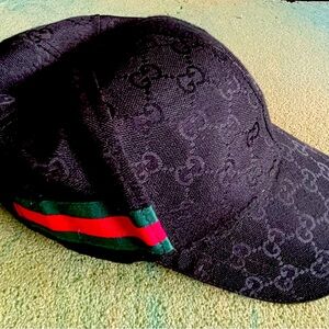 Black Gucci GG Canvas baseball cap with velcro strap closure at back.